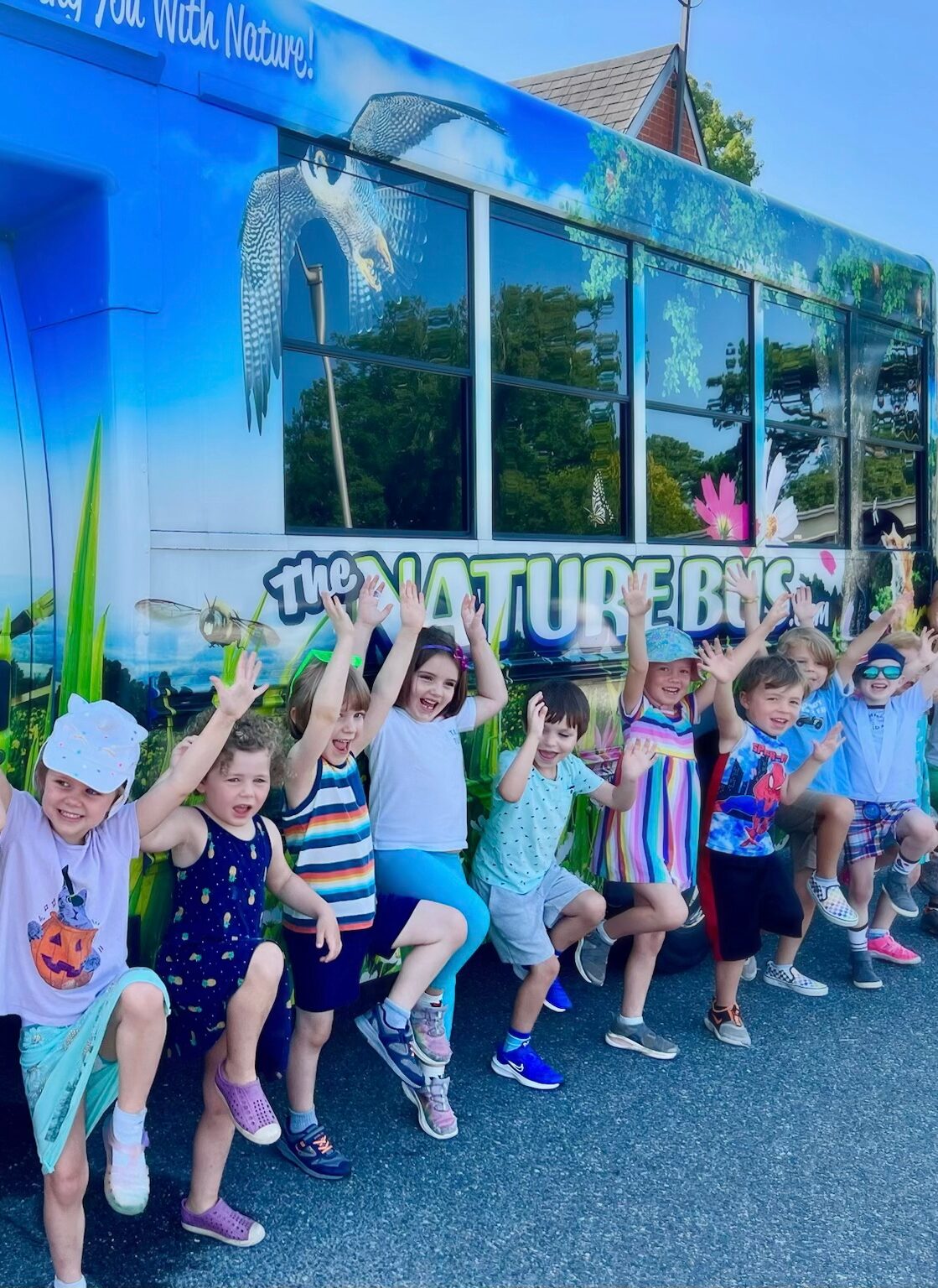 Children posing for picture in front of The Nature Bus