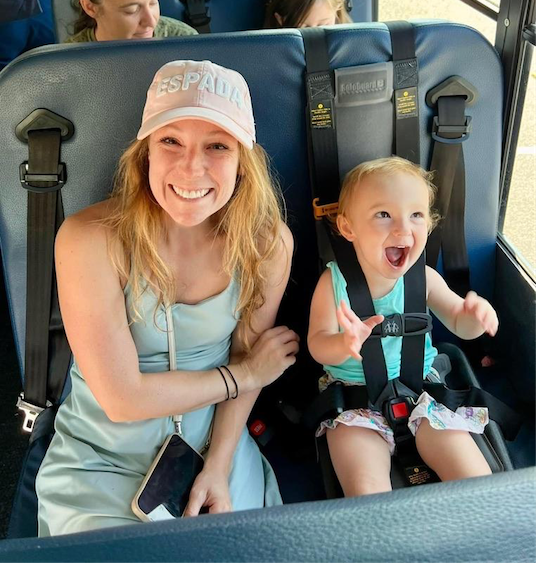 Very excited cute child next to mother on a bus seat